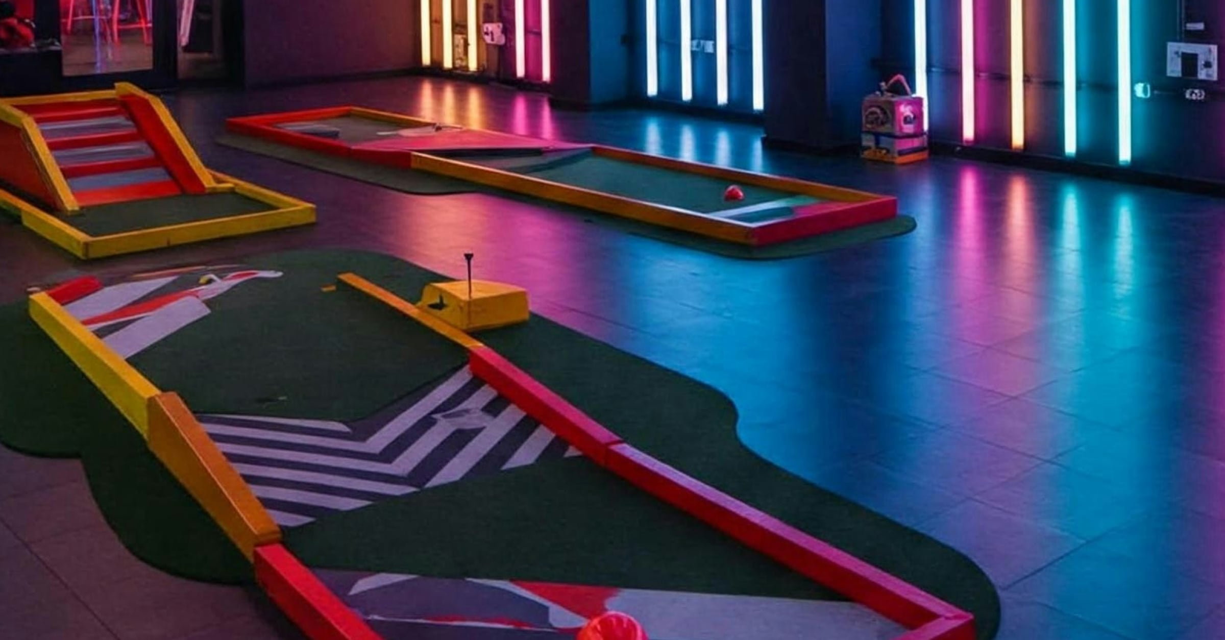 Indoor neon mini-golf venue